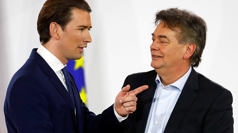 Head of Austria's Green Party Werner Kogler and head of People's Party (OeVP) Sebastian Kurz talk after delivering a statement in Vienna