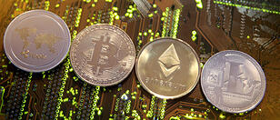 FILE PHOTO: Representations of the Ripple, Bitcoin, Etherum and Litecoin virtual currencies are seen on motherboard in this illustration picture
