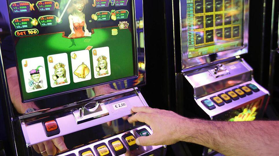 Man plays on a slot machine in a bingo hall in downtown Rome