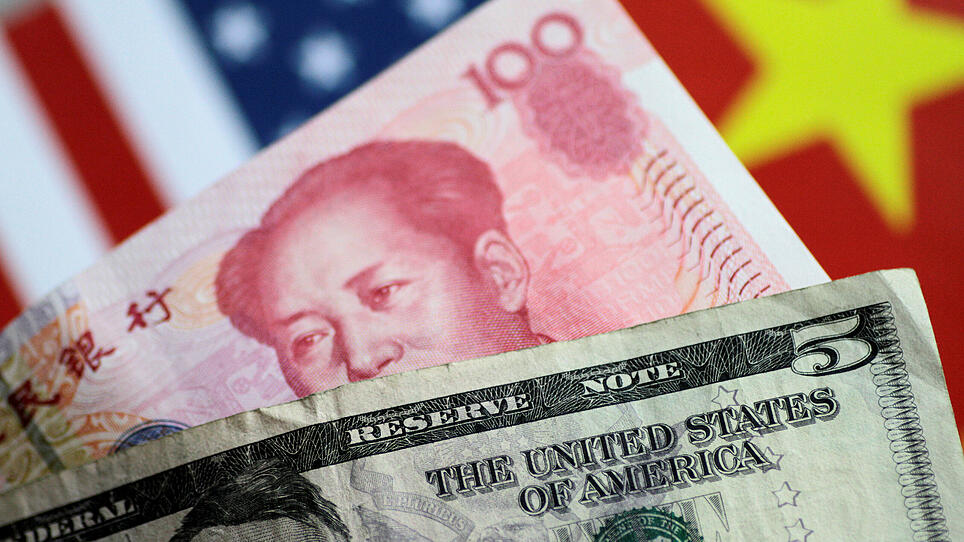 FILE PHOTO: Illustration photo of U.S. Dollar and China Yuan notes