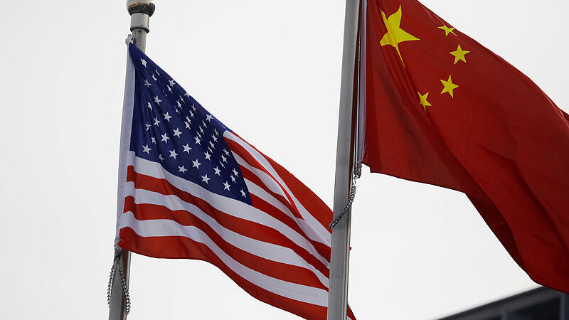 FILE PHOTO: Chinese and U.S. flags flutter outside the building of an American company in Beijing