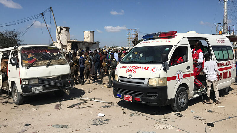 An ambulance leaves from the scene of a car bomb explosion at a checkpoint in Mogadishu