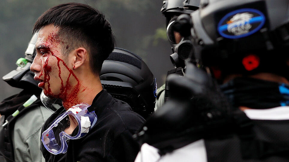 Protesters clash with riot police in the campus of Hong Kong Polytechnic University in Hong Kong