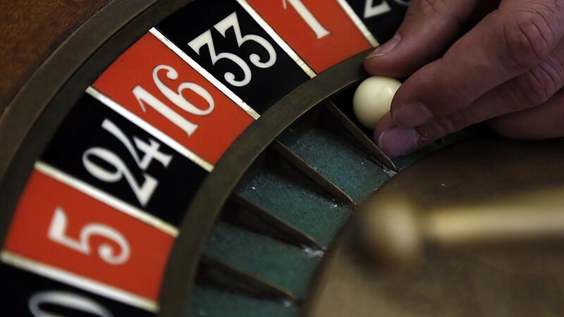 A young croupier trainee turns the roulette at a gaming table at the Cerus Casino Academy in Marseille