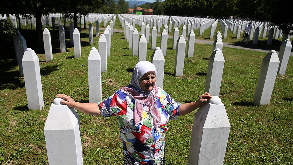 Mujic Suhreta cries at the graves of her two sons and a husband at Potocari-Srebrenica Memorial, in Potocari