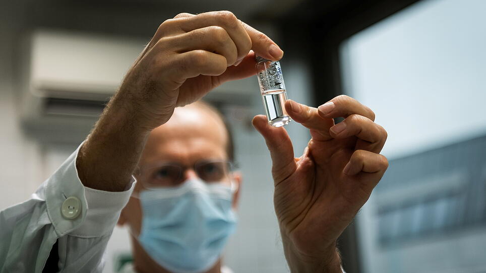 Laboratory assistant holds a tube with Russia's "Sputnik-V" vaccine against the coronavirus disease (COVID-19) at the National Institute of Pharmacy and Nutrition in Budapest