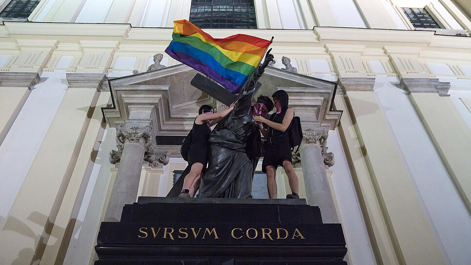 Activists place LGBT flag on Jesus statue in Warsaw
