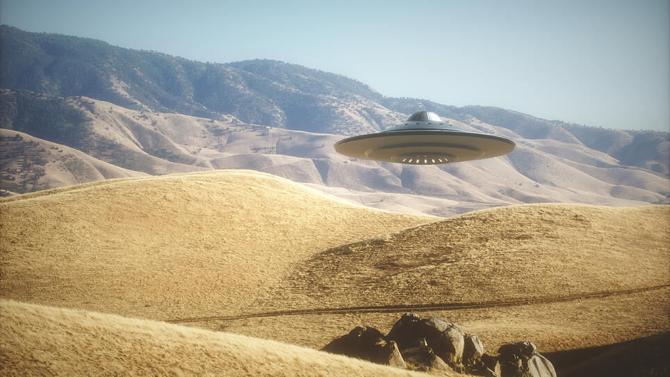 3D illustration with photography. Alien spaceship flying among the mountains. (iDesign)
