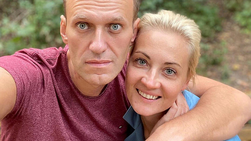 Russian opposition politician Alexei Navalny and his wife Yulia Navalnaya pose for a picture in an unknown location