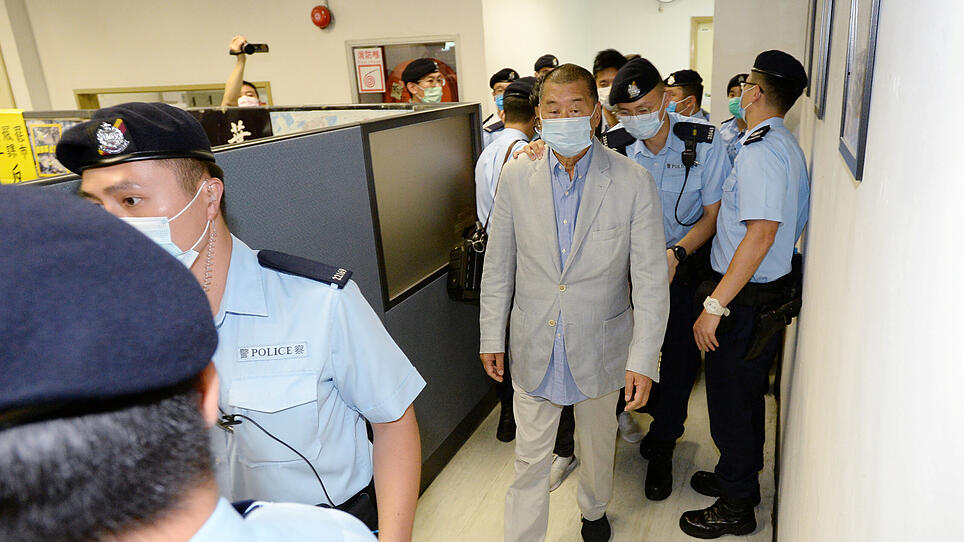Media mogul Jimmy Lai Chee-ying, founder of Apple Daily is seen escorted by Hong Kong police at the Apple Daily office in Hong Kong