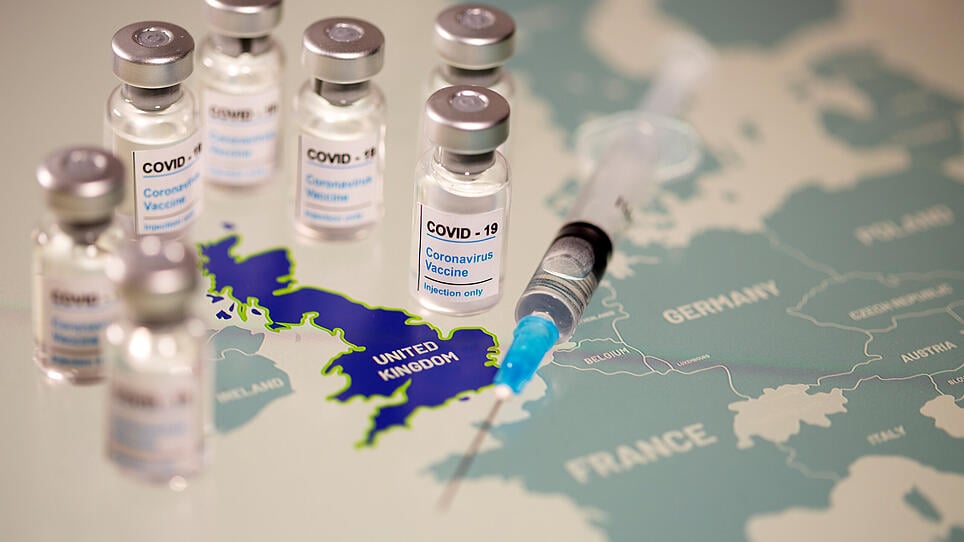 FILE PHOTO: Vials labelled "COVID-19 Coronavirus-Vaccine" and medical syringe are placed on the European Union map in this picture illustration
