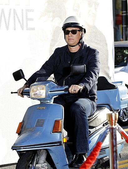 Hanks rides a scooter as he arrives at the world premiere of "Larry Crowne" at the Chinese theatre in Hollywood