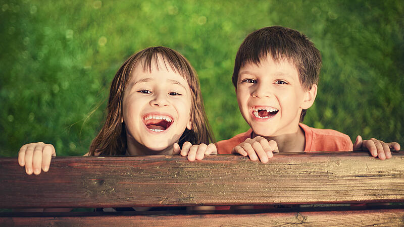Outdoor portrait of smiling girl and boy