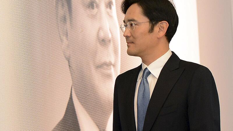 File photo of Jay Y. Lee, the only son of Samsung Electronics chairman Lee Kun-Hee, walking past a portrait of his father as he leaves after the 25th anniversary celebrating inauguration of Lee Kun-Hee as Samsung chairman in Seoul