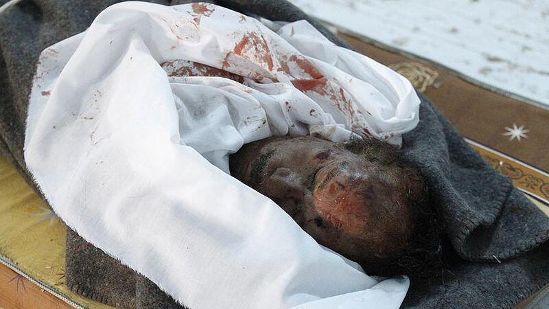 The body of slain Libyan leader Muammar Gaddafi is seen inside a storage freezer in Misrata
