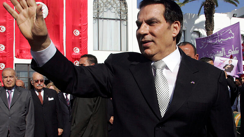 FILE PHOTO: Tunisia's President Zine al-Abidine Ben Ali waves to supporters after he took the oath at the national assembly in Tunis