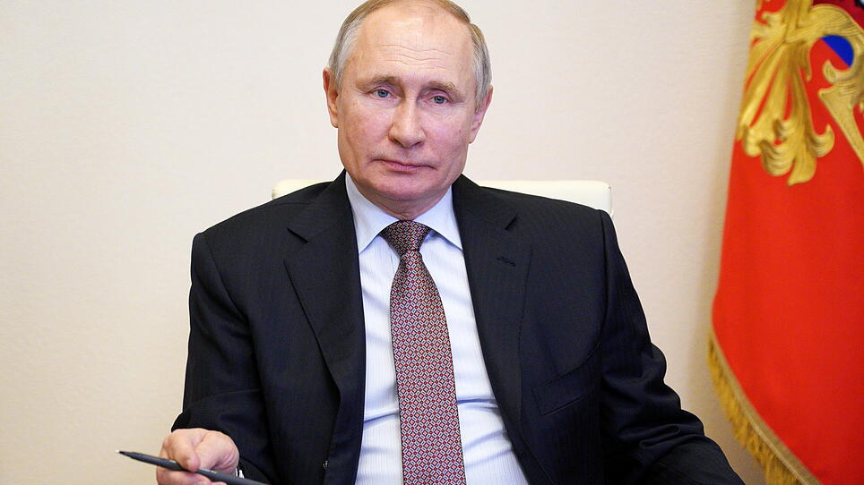 Russian President Vladimir Putin takes part in the signing ceremony via a video conference call outside Moscow