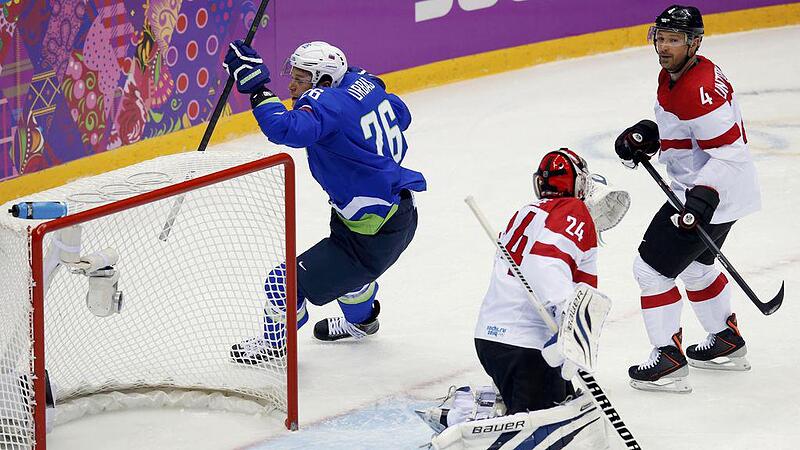 Slovenia's Urbas reacts after scoring on Austria's goalie Lange as Austria's Unterluggauer reacts during first period of their men's ice hockey playoffs qualification game at 2014 Sochi Winter Olympics