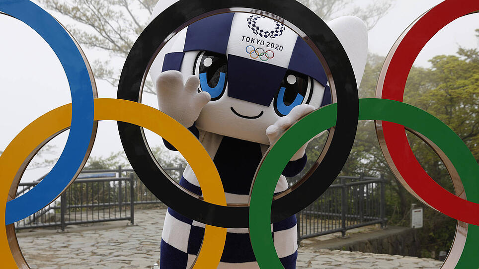 April 14, 2021, Hachioji, Japan: Tokyo 2020 Olympic Games mascot MIRAITOWA poses with a display of Olympic Symbol after