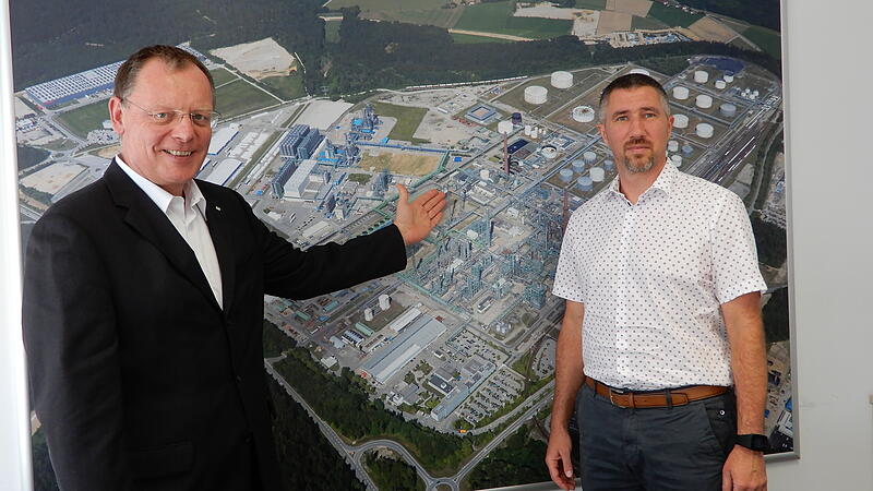 Vor dem OMV-Luftbild: Qualitätsmanager Robert Lackner (r.) und Geschäftsführer Gerhard Wagner, der auf den Fackelturm zeigt.