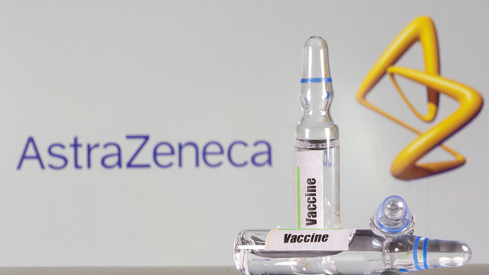 FILE PHOTO: FILE PHOTO: A test tube labelled with the vaccine is seen in front of AstraZeneca logo in this illustration taken