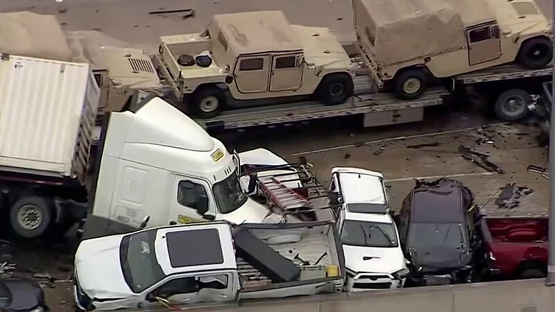 Cars and trucks are wedged together after a morning crash on the ice covered I-35 in Fort Worth
