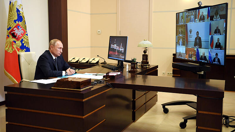 Russian President Putin chairs a meeting via video link outside Moscow