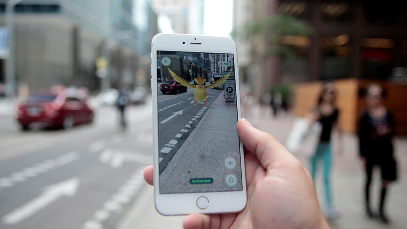 Photo illustration of a "Pidgey" Pokemon seen on the screen of the Pokemon Go mobile app