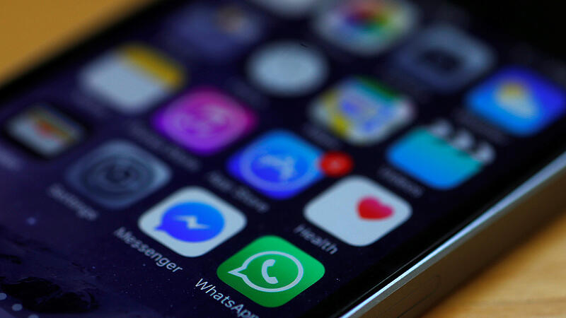 WhatsApp and Facebook messenger icons are seen on an iPhone in Manchester , Britain.