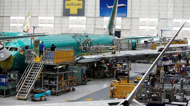 FILE PHOTO: People work near the door of a 737 Max aircraft at the Boeing factory in Renton