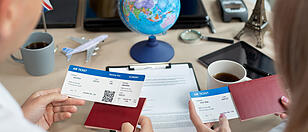 Close-up of passports and tickets in the hands of travelers at a travel agency