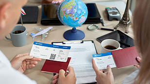 Close-up of passports and tickets in the hands of travelers at a travel agency