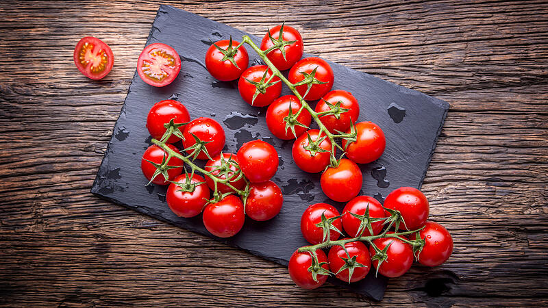 Fresh cherry tomatoes. Ripe tomatoes on oak wooden background