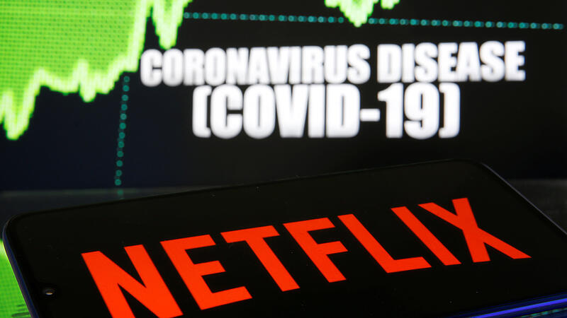 Netlix logo is seen in front of diplayed coronavirus disease (COVID-19)