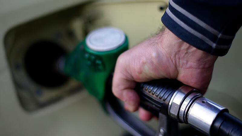 A man fills up his car at a petrol station in Rome