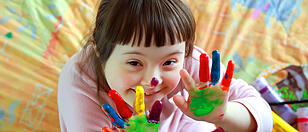 Cute little girl with painted hands