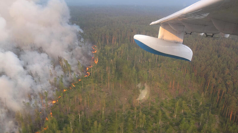 An aerial view shows flame and smoke rising from a wildfire in Krasnoyarsk region