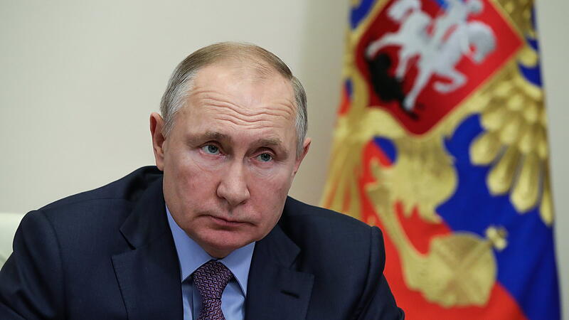 Russian President Vladimir Putin chairs a meeting with government members outside Moscow
