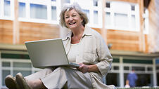 Senior woman using laptop on campus